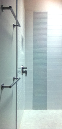 Shower with white ceramic tile with glass tile accent